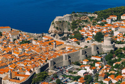 High angle view of townscape by sea