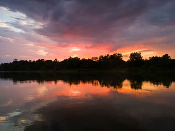 Scenic view of lake against orange sky