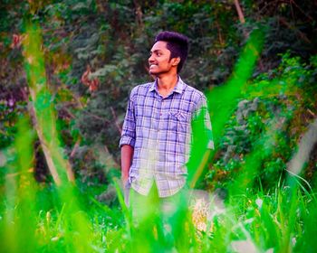 Portrait of young man standing on land