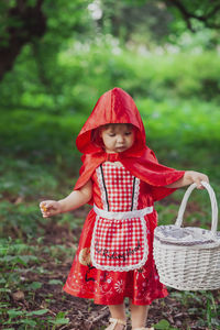Charming baby in a red riding hood costume 