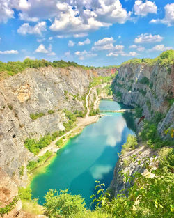 Scenic view of lake amidst mountains against sky