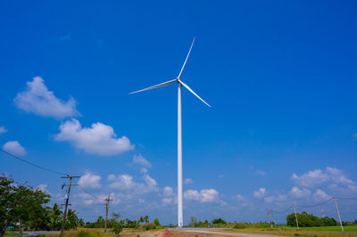 Windmill on field against sky