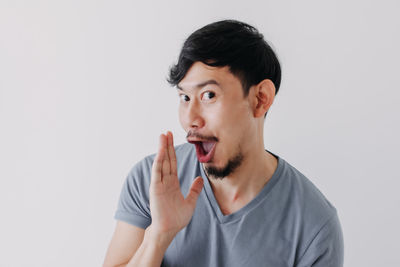 Portrait of young man against white background