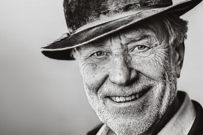 Close-up portrait of senior man wearing hat