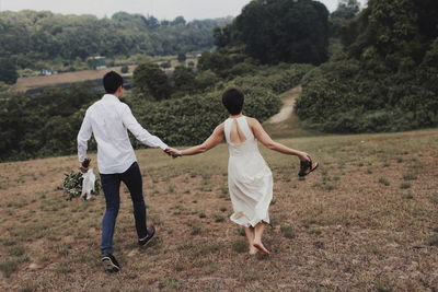 Rear view of couple walking on street