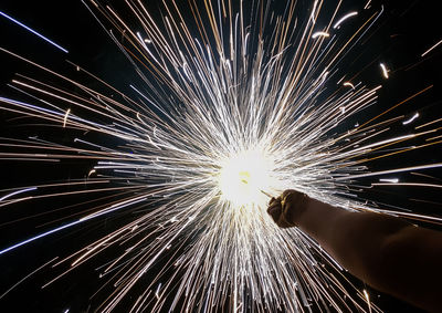 Low angle view of fireworks exploding at night