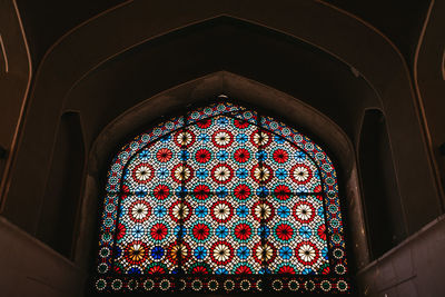 Low angle view of stained glass window in building