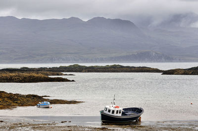 Sailboats moored at beach