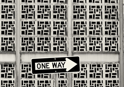 One way sign against patterned wall