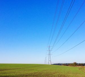 Scenic view of agricultural field against clear blue sky