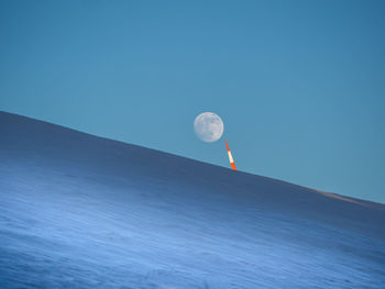 Scenic view of moon against clear blue sky