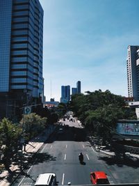 City street and buildings against sky