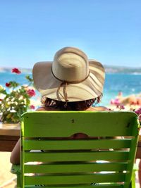 Rear view of woman wearing hat against clear sky