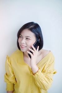 Portrait of smiling young woman using mobile phone