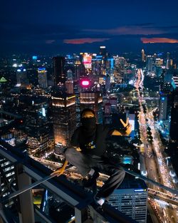 High angle view of illuminated modern buildings in city at night