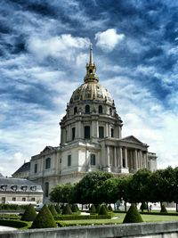 Low angle view of building against cloudy sky