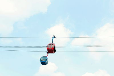 Low angle view of traffic signal against sky