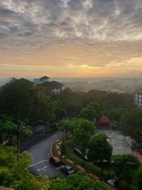 High angle view of city street against sky at sunset