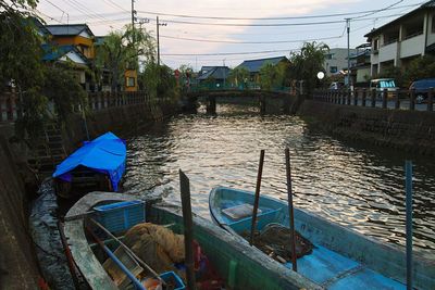 Boats moored on shore against sky