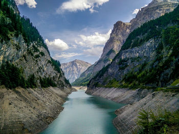 Scenic view of river amidst mountains