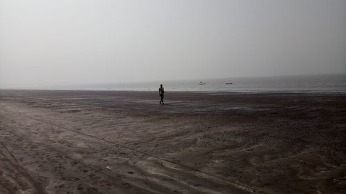 Scenic view of beach against clear sky