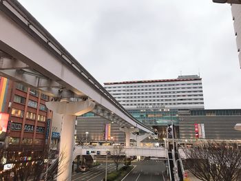 Bridge in city against sky