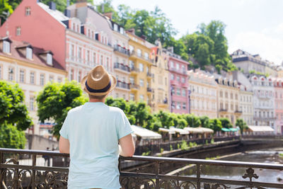 Rear view of man looking at city buildings