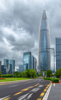 View of city buildings against cloudy sky