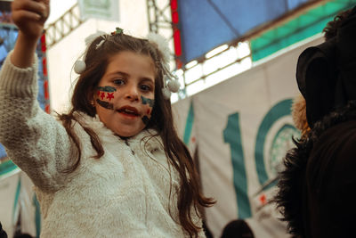 Cute girl with face paint outdoors