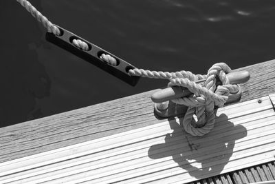 Cropped image of boat with rope tied on cleat