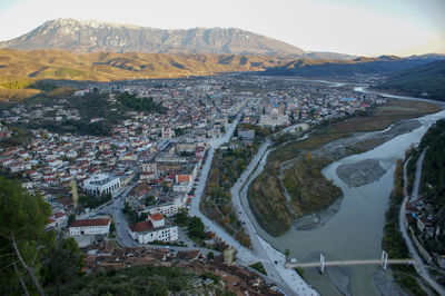 High angle view of townscape and mountains against sky