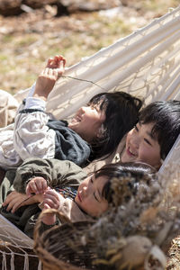 Cute kids lying on hammock outdoors