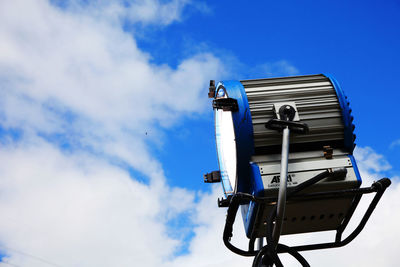 Low angle view of electric lamp against blue sky