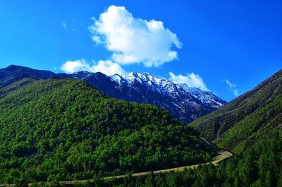 Scenic view of mountains against blue sky