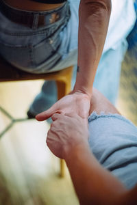 Low section of man holding hands