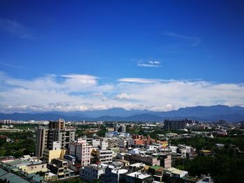 High angle view of cityscape against cloudy sky