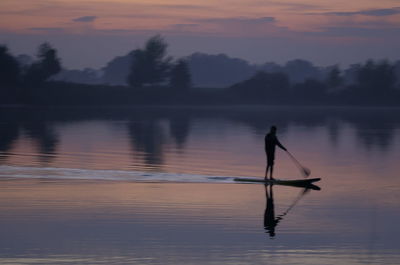 Rear view of man jumping in lake