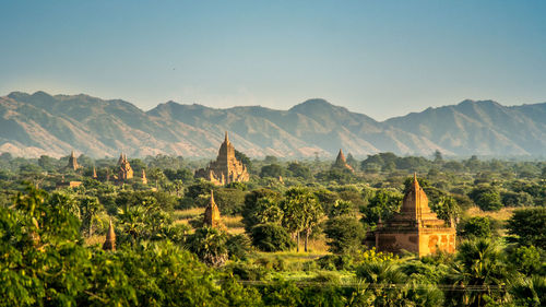 Old buddhist temples by mountains against sky