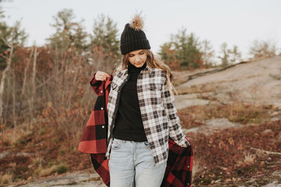 Portrait of teenage girl wearing hat standing on land