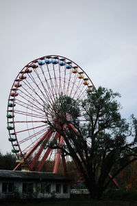 Low angle view of ferris wheel against sky