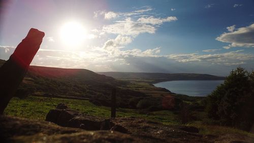 Scenic view of landscape and sea against sky