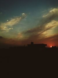 Silhouette of built structure at sunset