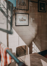 Person holding umbrella in bathroom