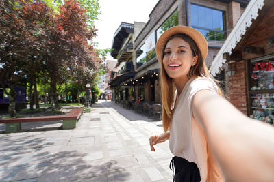 Young stylish woman takes self portrait in gramado town on christmas time, rio grande do sul, brazil