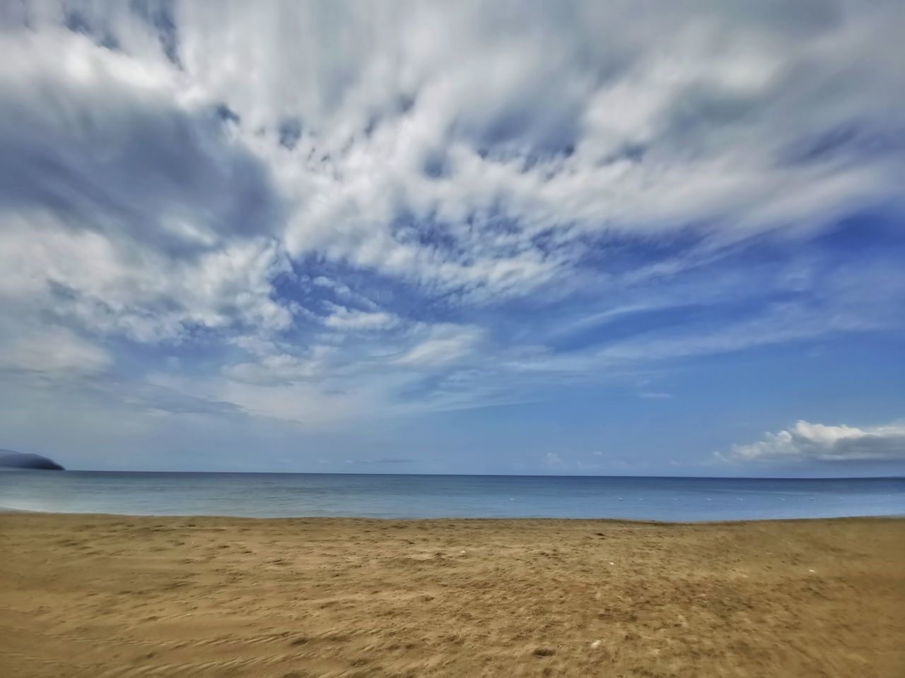 SCENIC VIEW OF BEACH AGAINST CLOUDY SKY