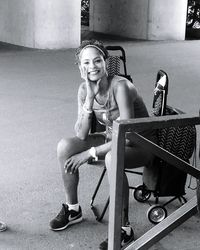 Portrait of a smiling young woman sitting on chair