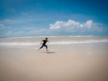 Full length of man on beach against sky