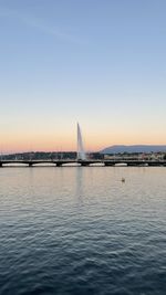 Sailboats in city at sunset