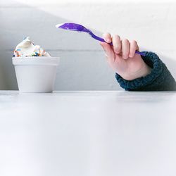 Low section of woman holding spoon