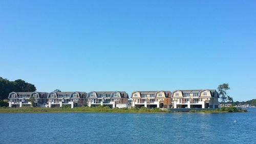 View of buildings against clear blue sky